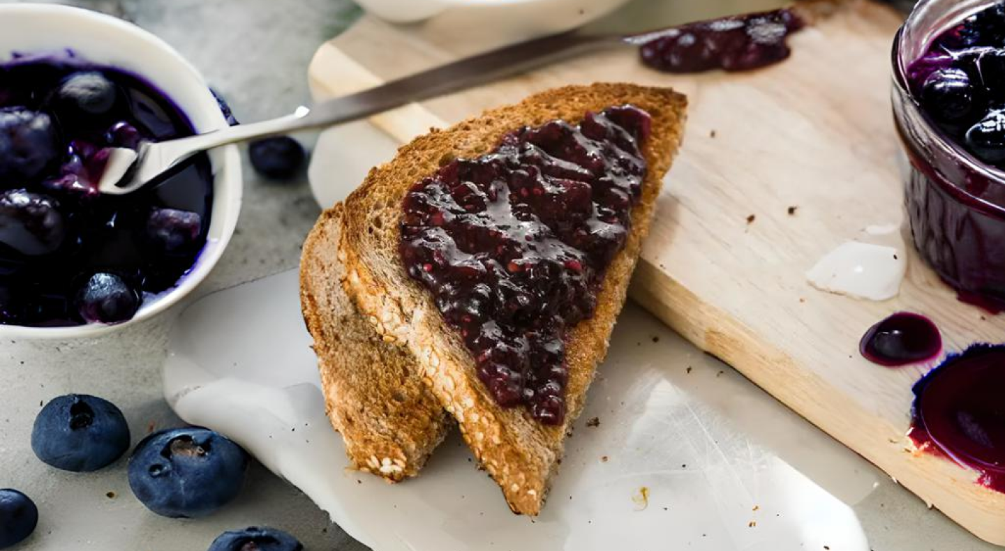 A slice of toast spread with vegan jam