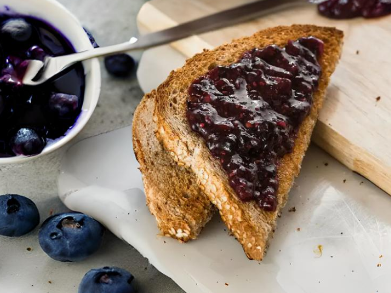 A slice of toast spread with vegan jam