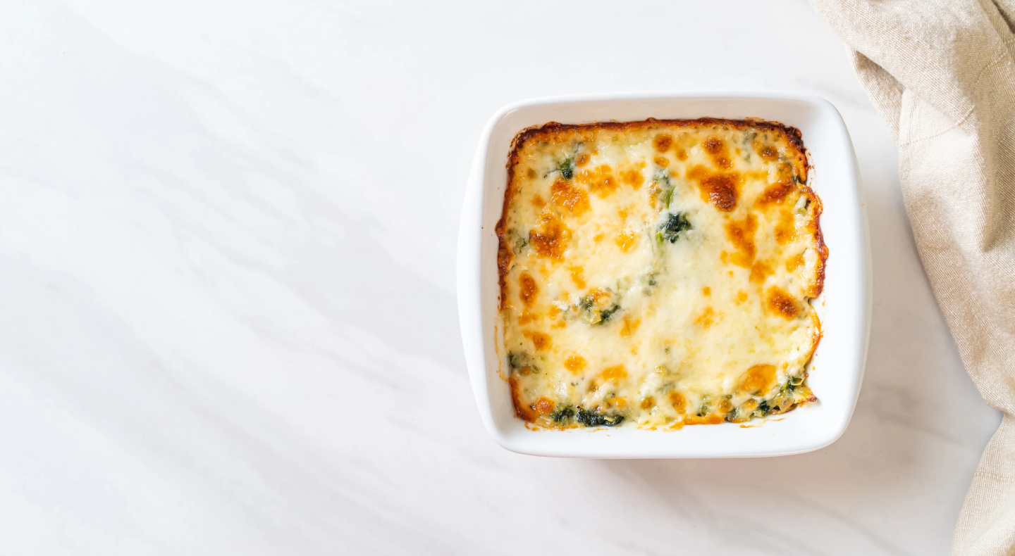 A cheesy-looking dip in a white dish