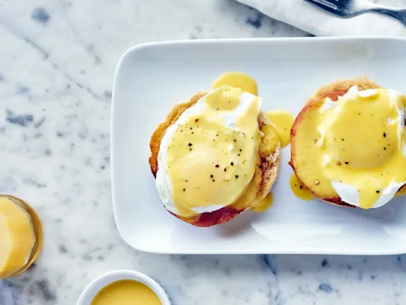 Toasted bagel with vegan eggs on a plate