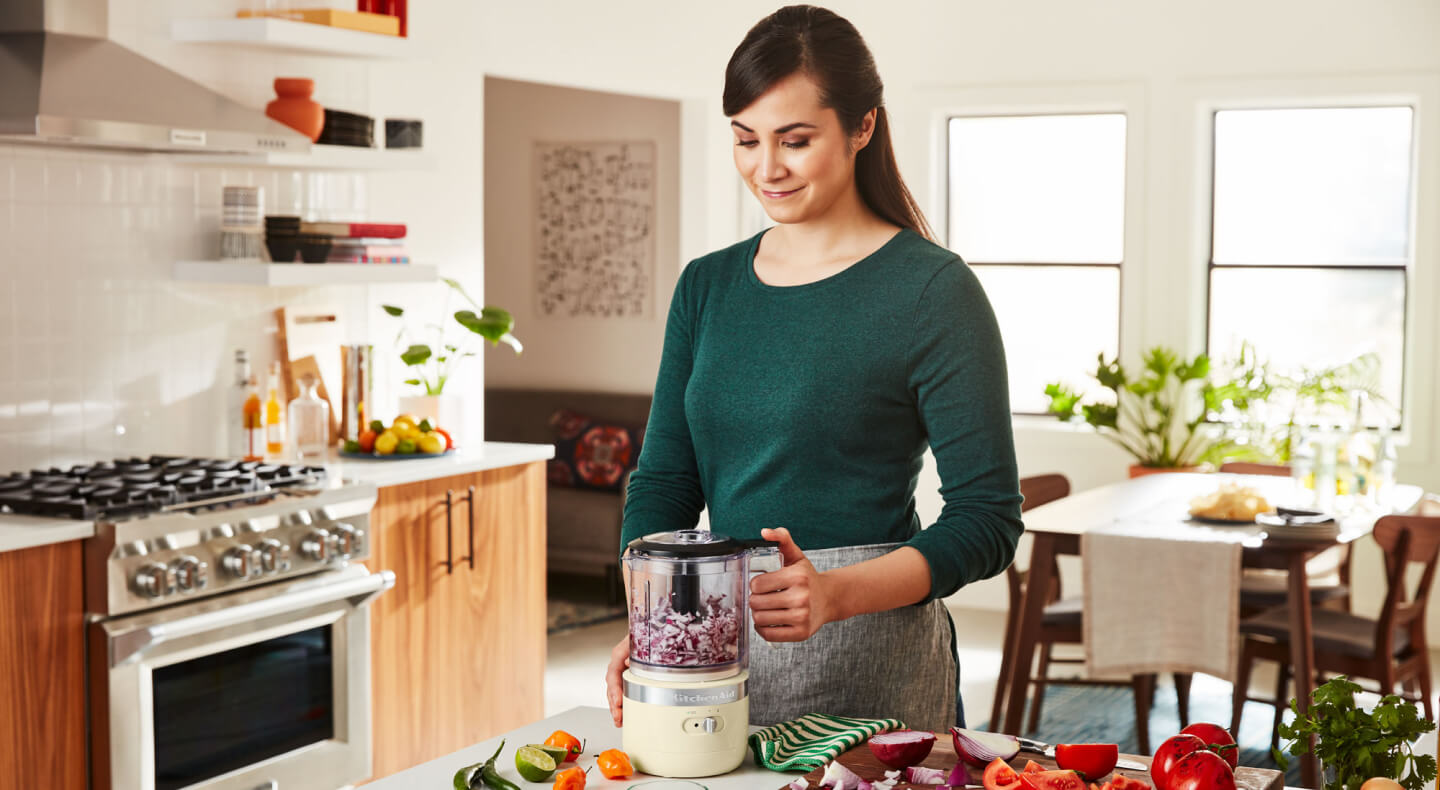 Person using a KitchenAid® cordless food chopper