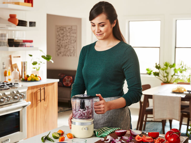 Person using a KitchenAid® cordless food chopper
