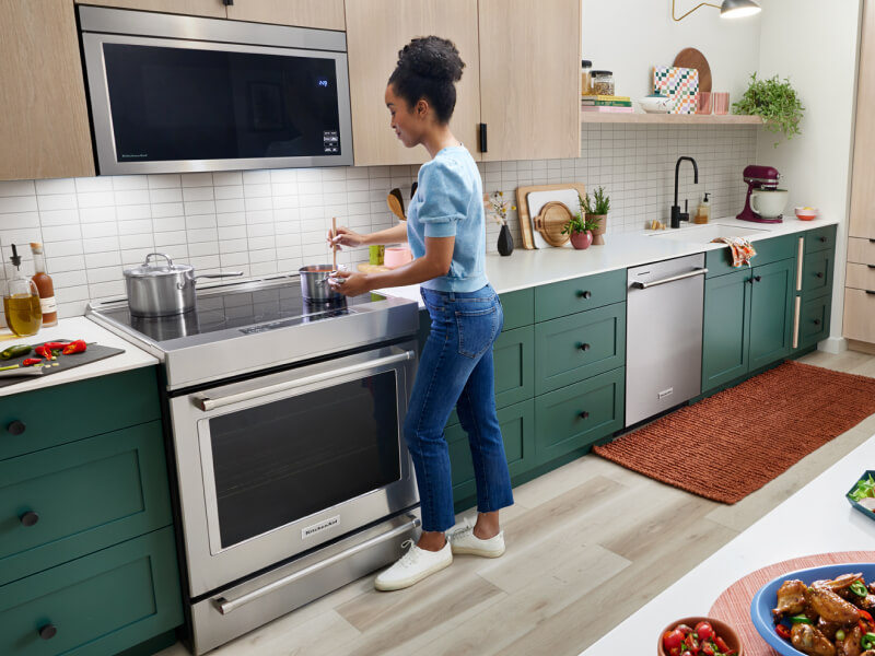 A person stirring a pot on their stove