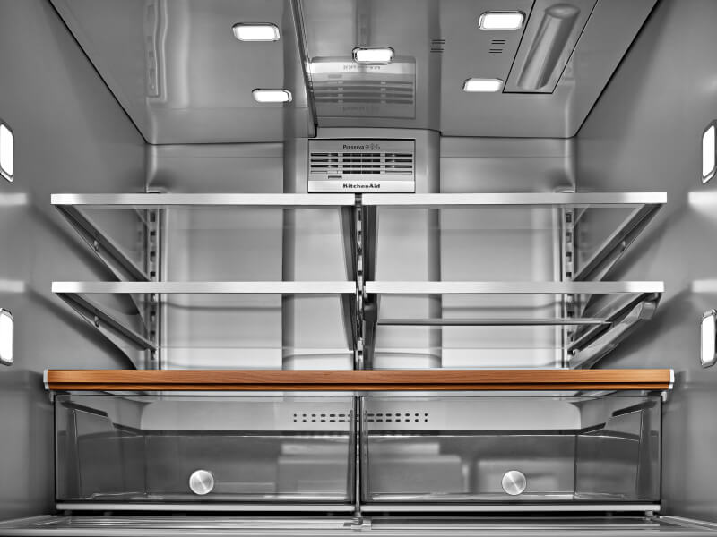 The inside of a well-lit KitchenAid® refrigerator 