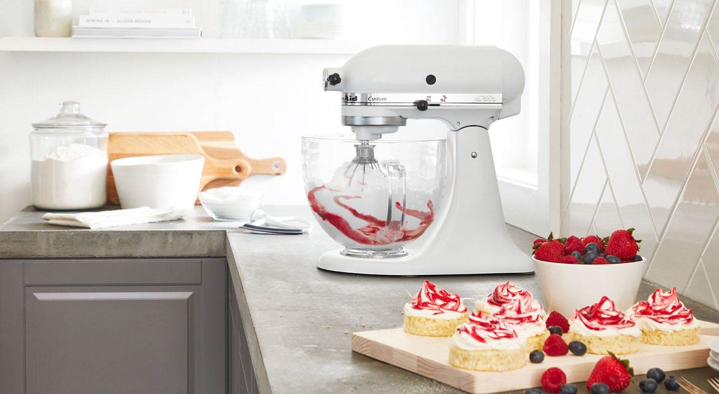 White KitchenAid® mixer with whip accessory