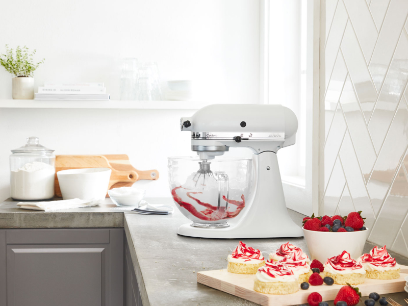 White KitchenAid® mixer with whip accessory