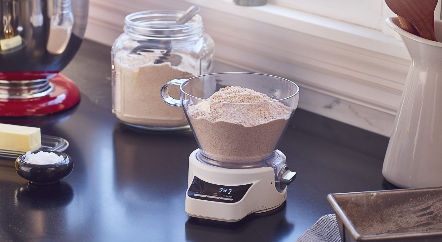 A container of flour being weighed.