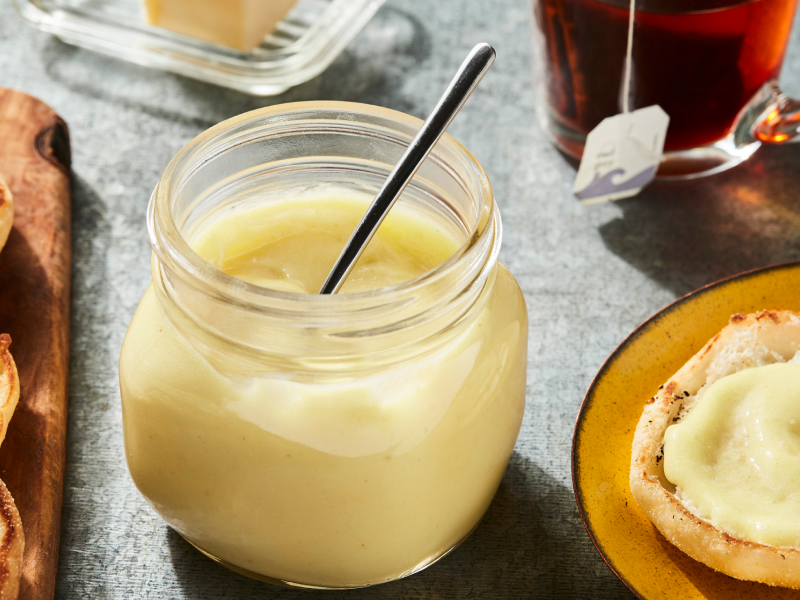 Jar of lemon curd with muffins