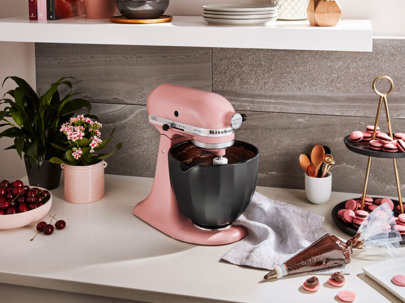 KitchenAid® stand mixer with black bowl next to homemade macaroons