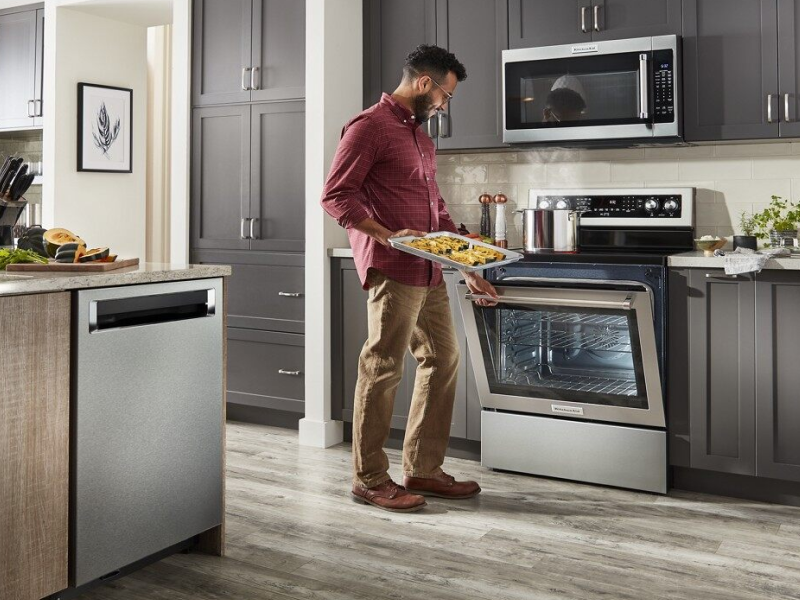 Person baking snacks in KitchenAid® oven