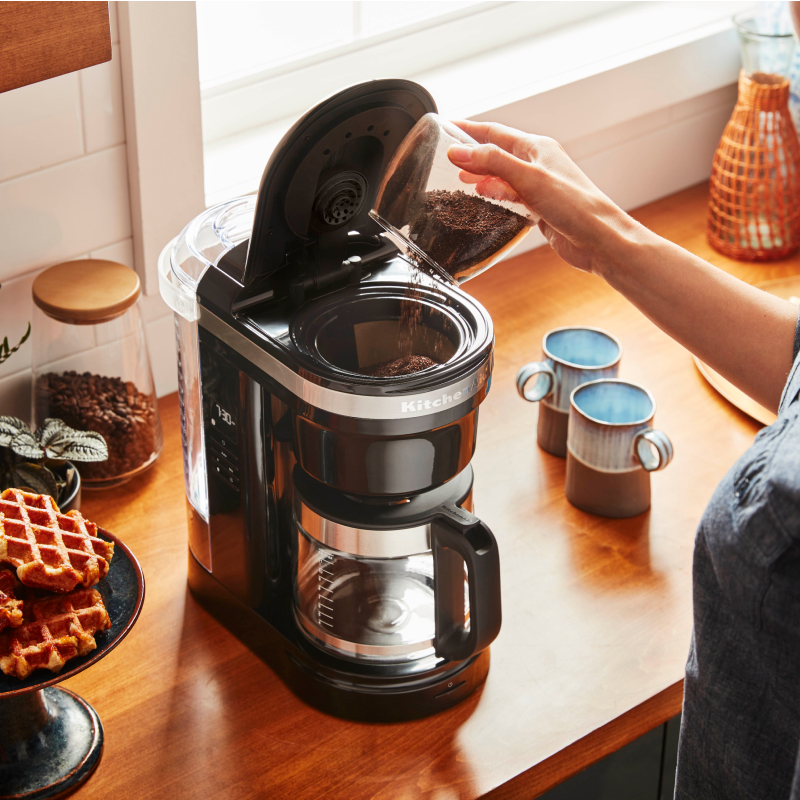 Person making coffee with a KitchenAid® Drip Coffee Maker