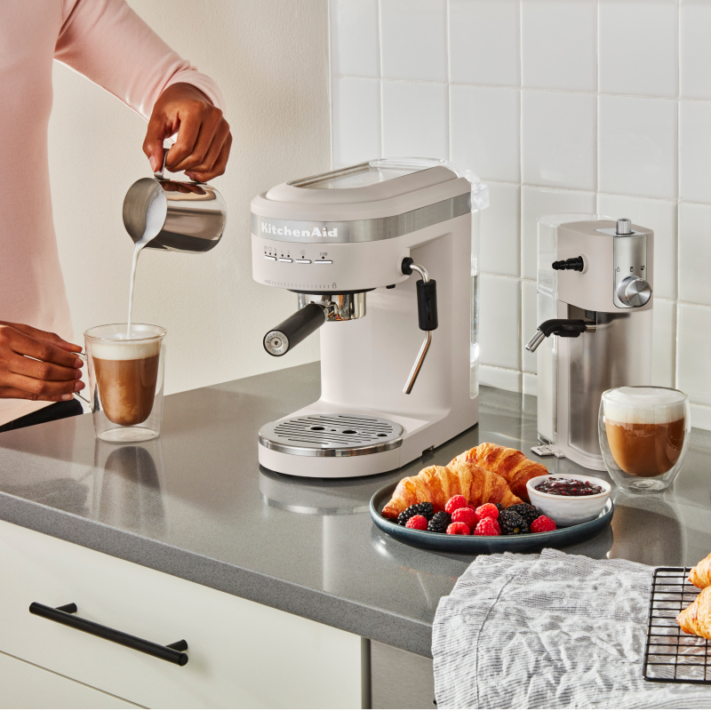 Coffee bar with a white KitchenAid® Espresso Maker, Milk Frother Attachment and Burr Grinder