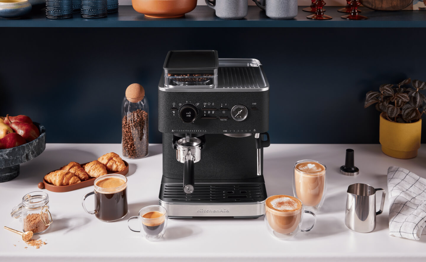 Black KitchenAid® Semi-Automatic Espresso Machine surrounded by espresso drinks