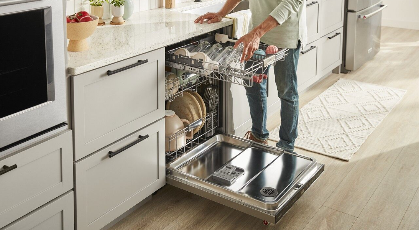 Man loading a dishwasher 