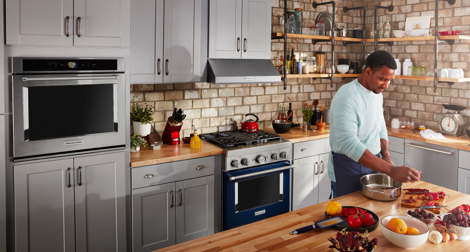 KitchenAid® wall oven and commercial range in a kitchen