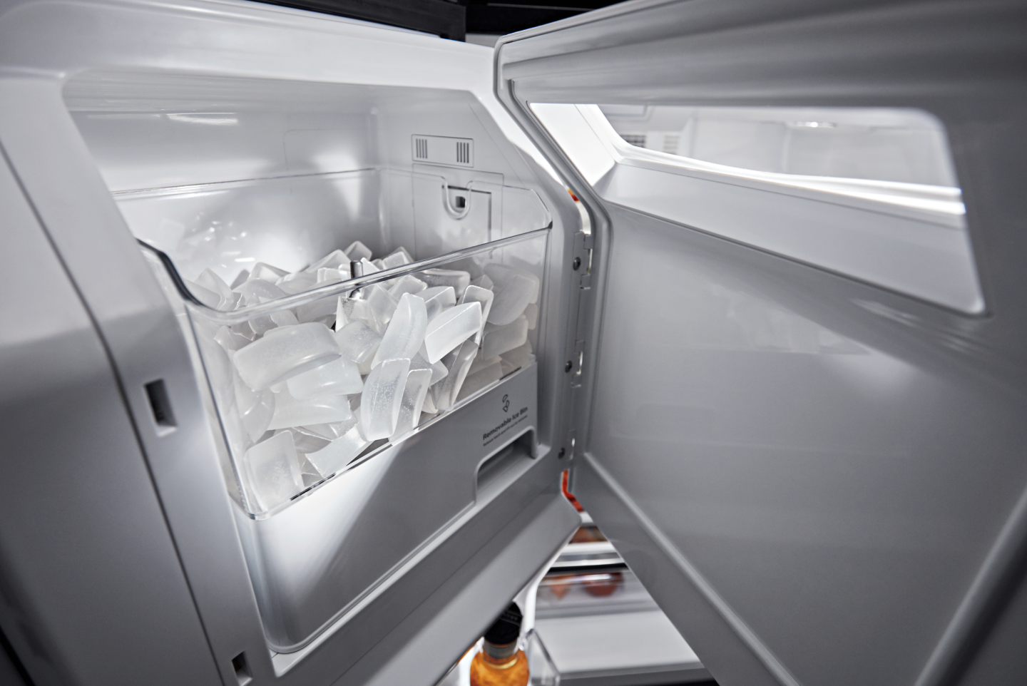 Open in-door ice maker full of ice
