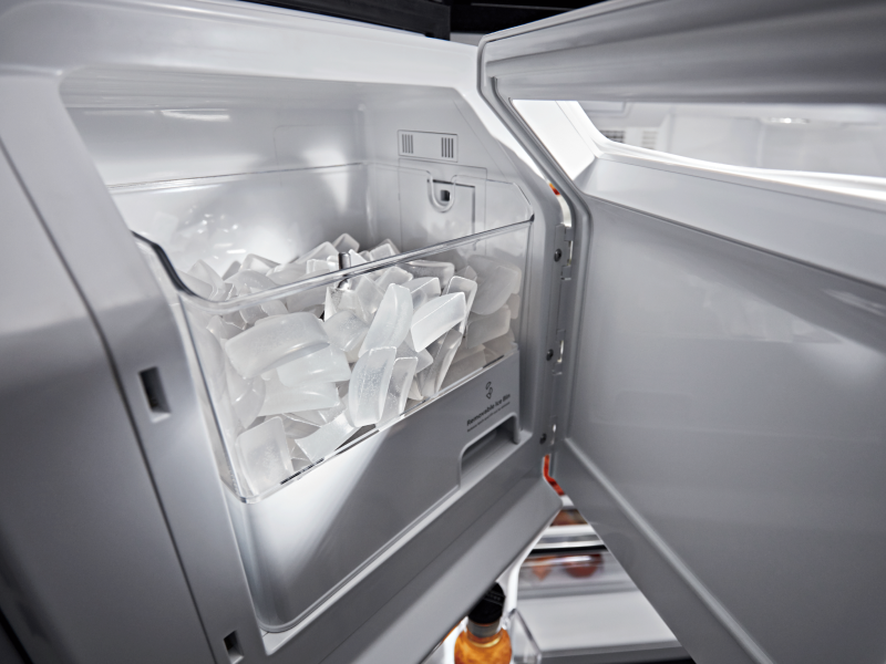 Open in-door ice maker full of ice