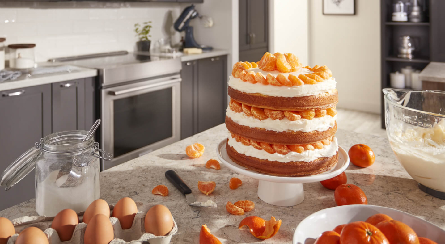 A layered cake with tangerines and cream