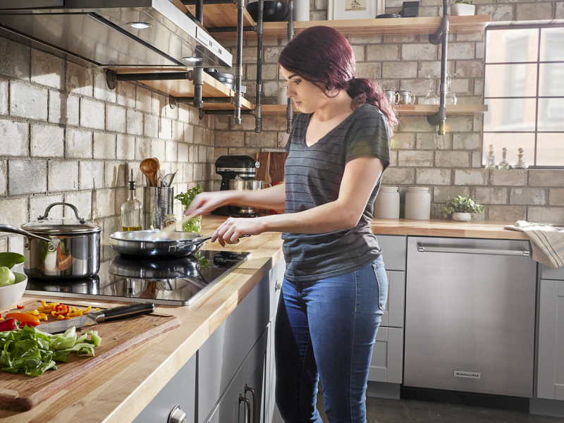 Person cooking at a cooktop