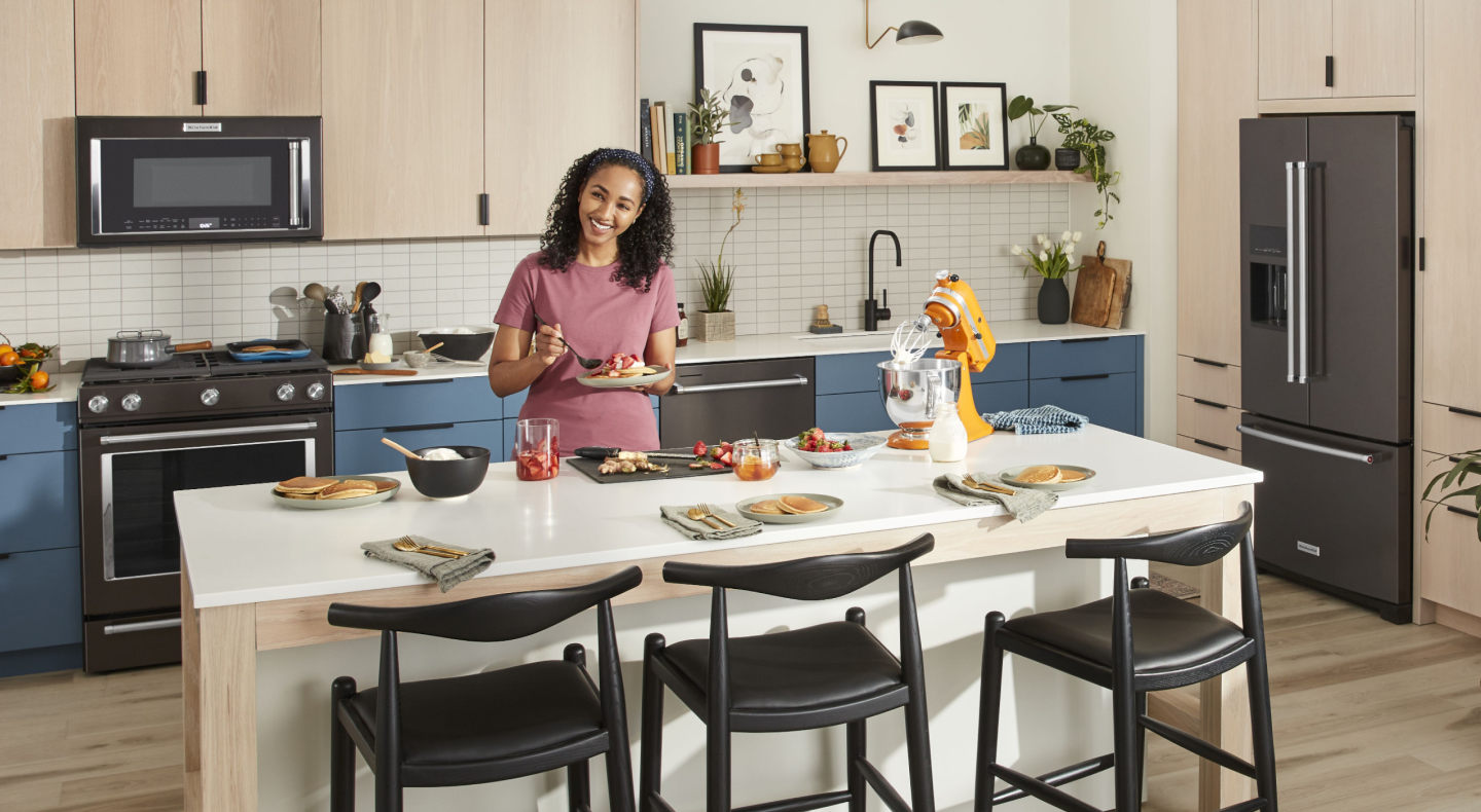 Person preparing place settings at kitchen island