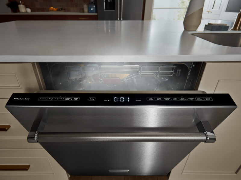 Top-control dishwasher door cracked open with steam coming out