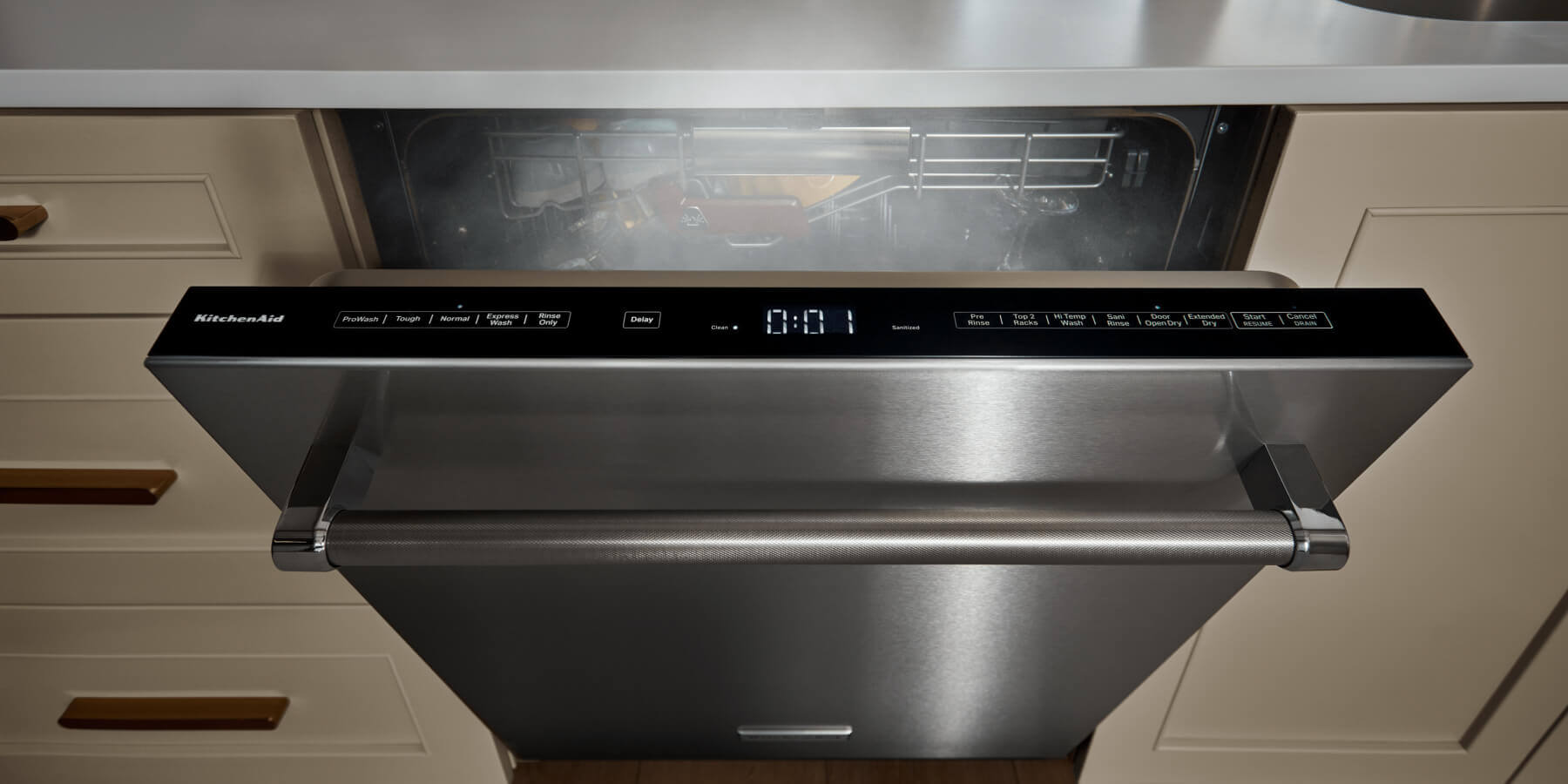Top-control dishwasher door cracked open with steam coming out