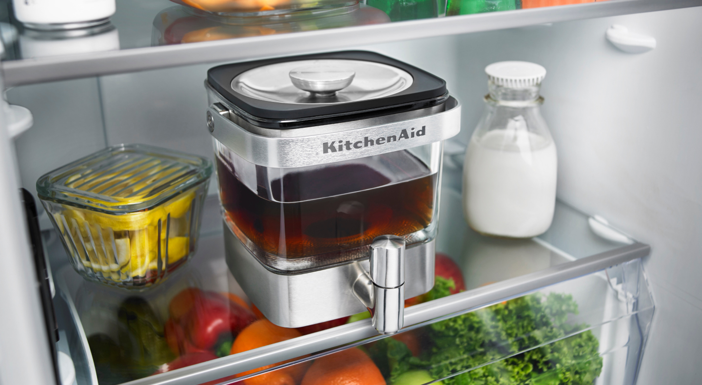 KitchenAid® cold brew maker filled with tea in a refrigerator 