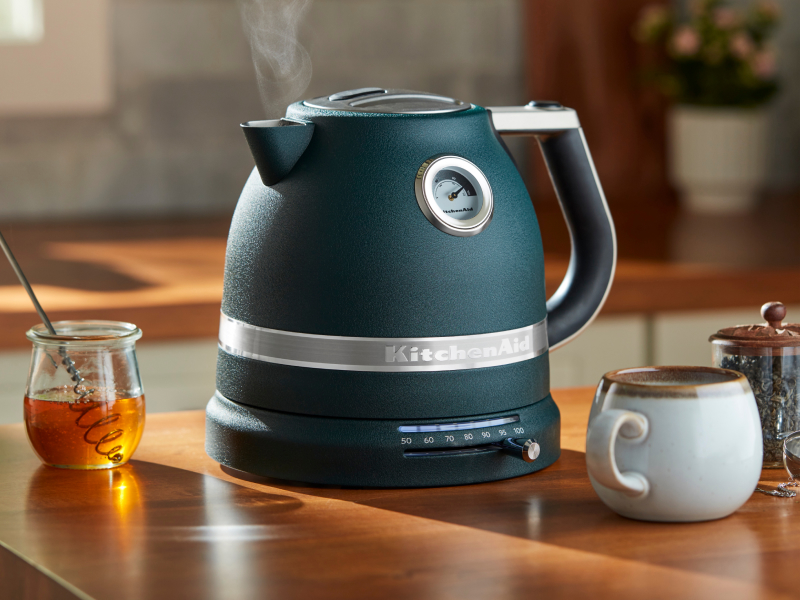 Teal KitchenAid® electric kettle next to tea and honey