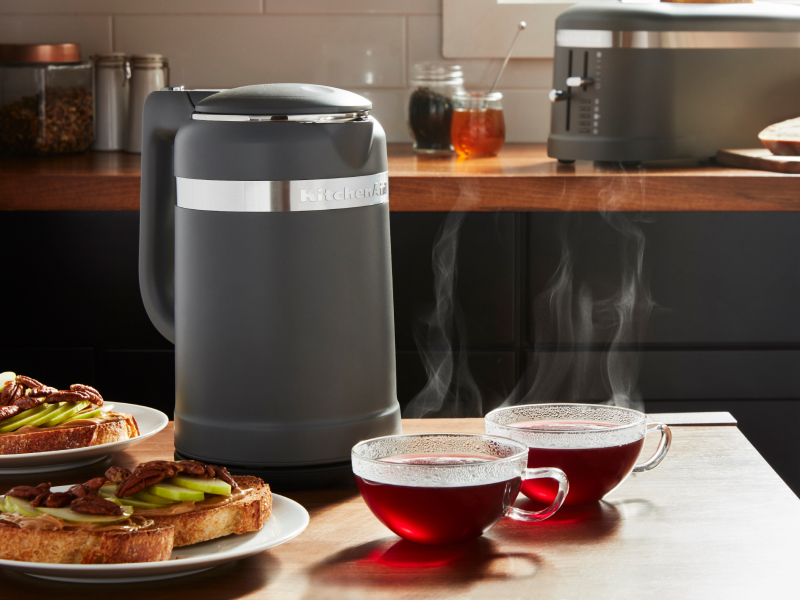 Black KitchenAid® electric kettle next to two glass mugs of tea
