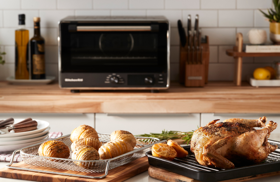 KitchenAid® Air Fryer Countertop Oven in kitchen with air fried potatoes and whole chicken