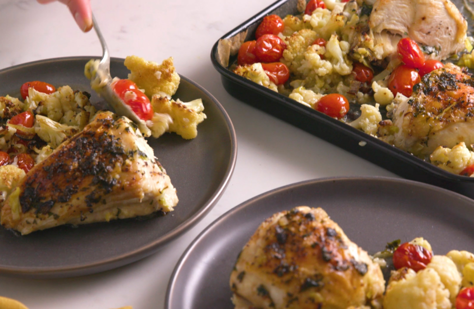 Air fried chicken breasts on a pan with side dish