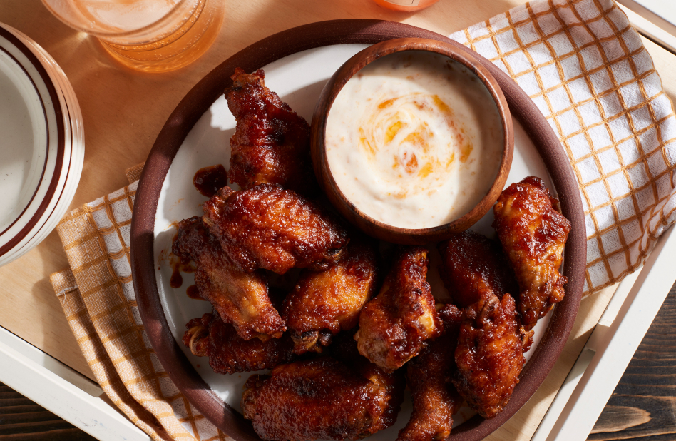 A plate of air fried chicken wings with a side of ranch