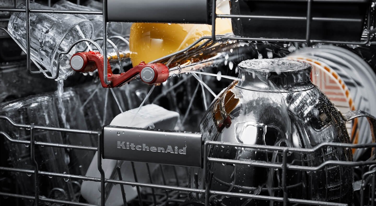 Dishes getting cleaned inside a KitchenAid® dishwasher