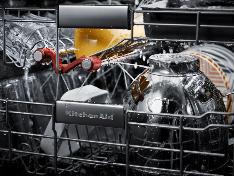 Dishes getting cleaned inside a KitchenAid® dishwasher