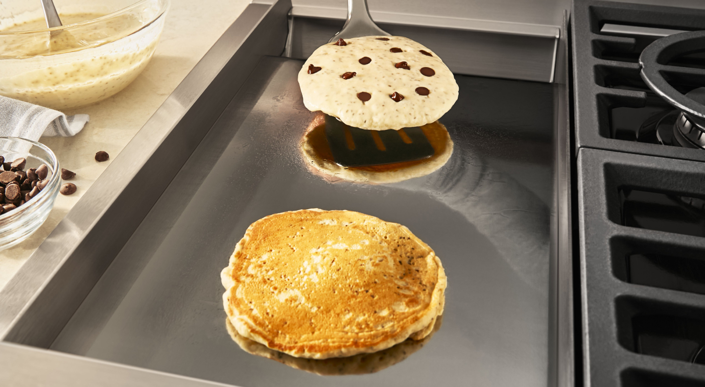 Chocolate chip pancakes on a griddle