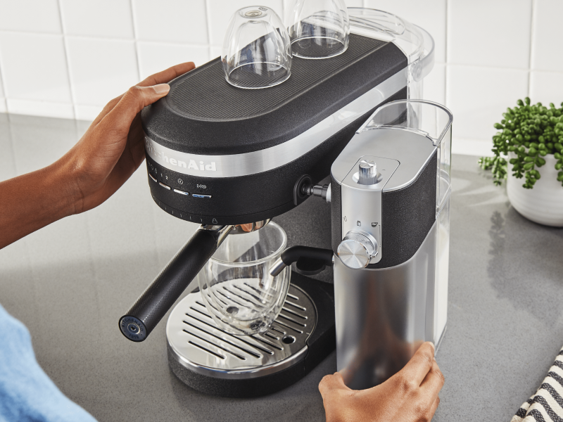 Person removing Automatic Milk Frother Attachment from KitchenAid® Espresso Machine