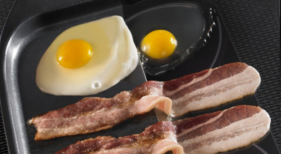 Bacon and eggs sizzling on an induction cooktop