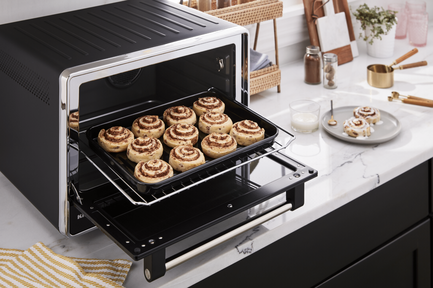 Baking tray of cinnamon rolls inside a countertop oven