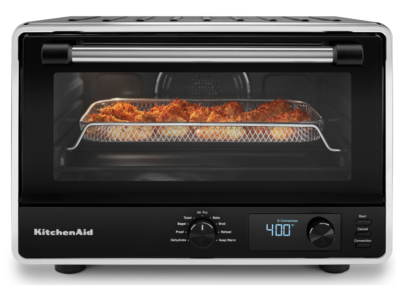 A KitchenAid® countertop oven with a basket of air fryer shrimp.
