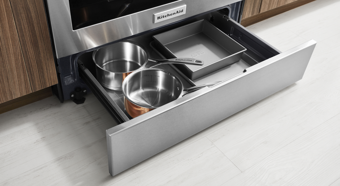 Drawer open with pots and pans stored in it