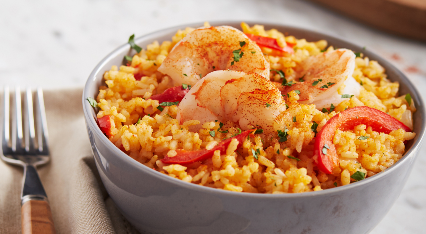Spanish paella with shrimp in a gray bowl