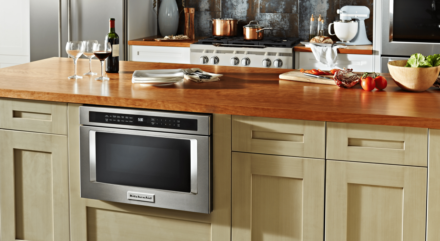 A stainless steel KitchenAid® built-in microwave in a modern kitchen