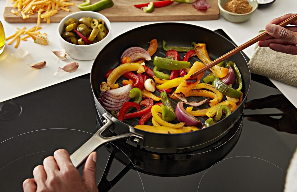 Veggies stir frying on an electric cooktop 