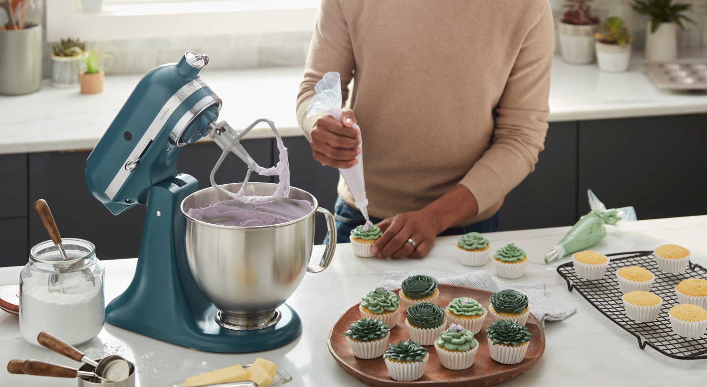Person using a KitchenAid® stand mixer