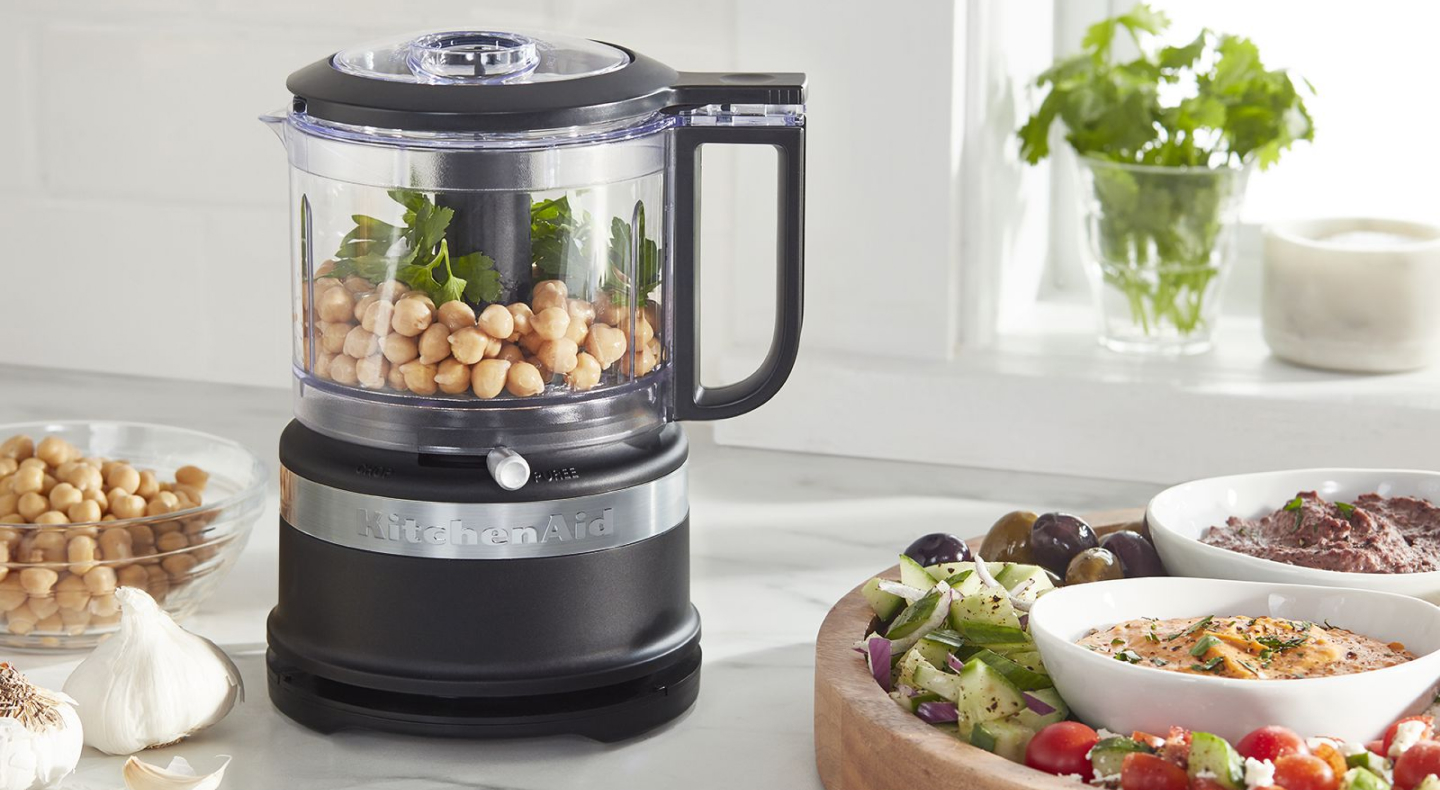 A KitchenAid® food processor full of charcuterie ingredients