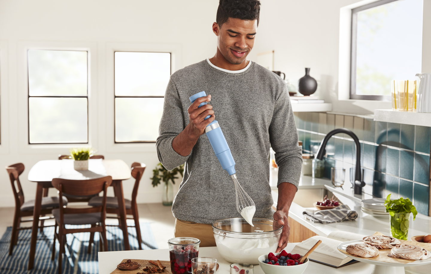 Man whipping cream with a hand blender