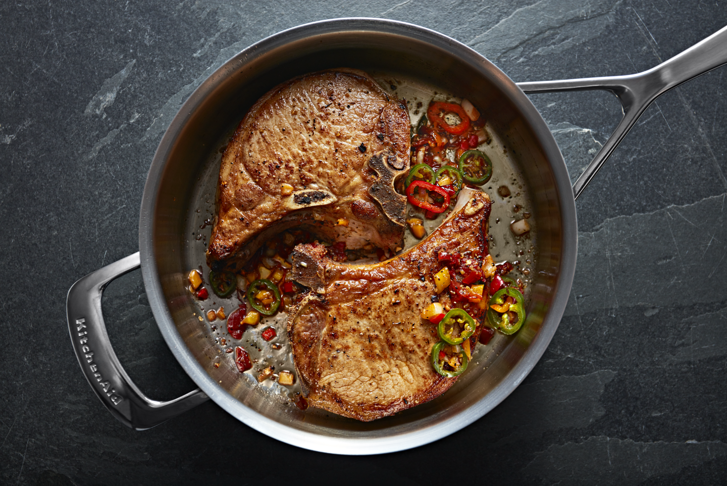 Two steaks inside a stainless steel pan