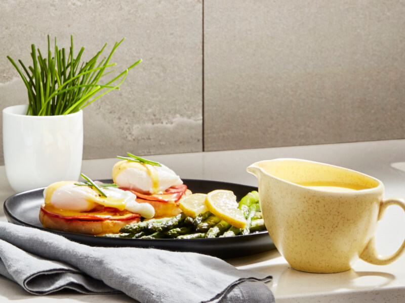 Eggs Benedict on a plate at a table