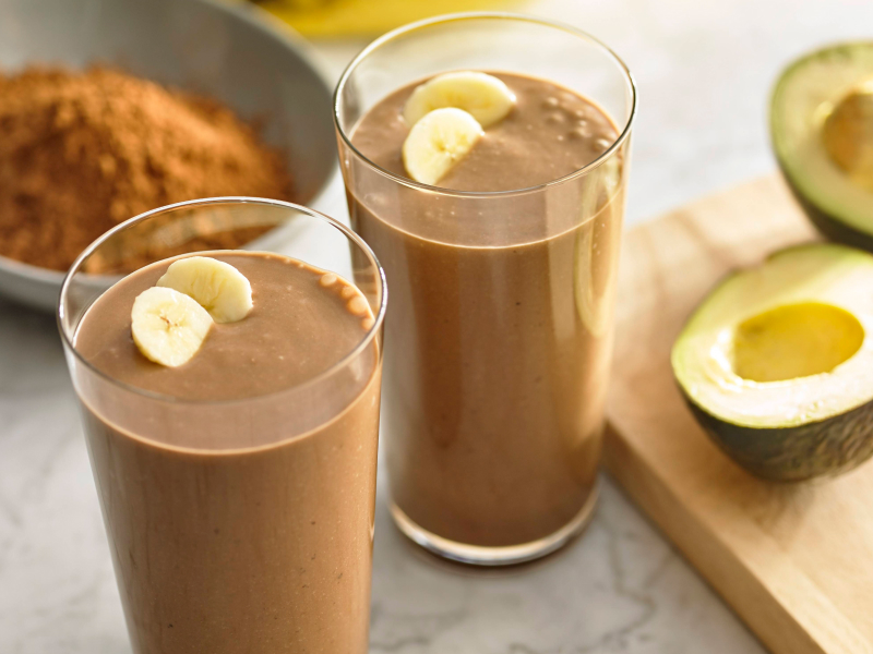 Glasses filled with blended chocolate drinks topped with fresh fruit