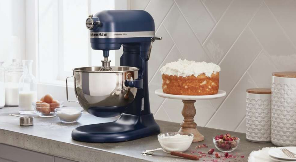 A KitchenAid® bowl-lift stand mixer next to a cake stand